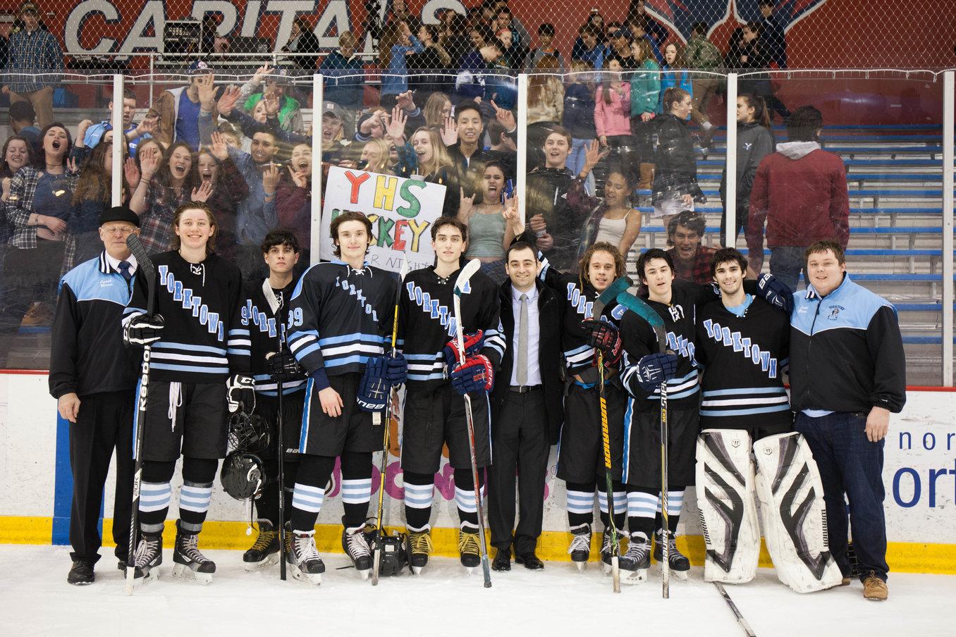 The seniors of the Yorktown hockey team stand victorious after their 5-3 win over Washington-Lee
