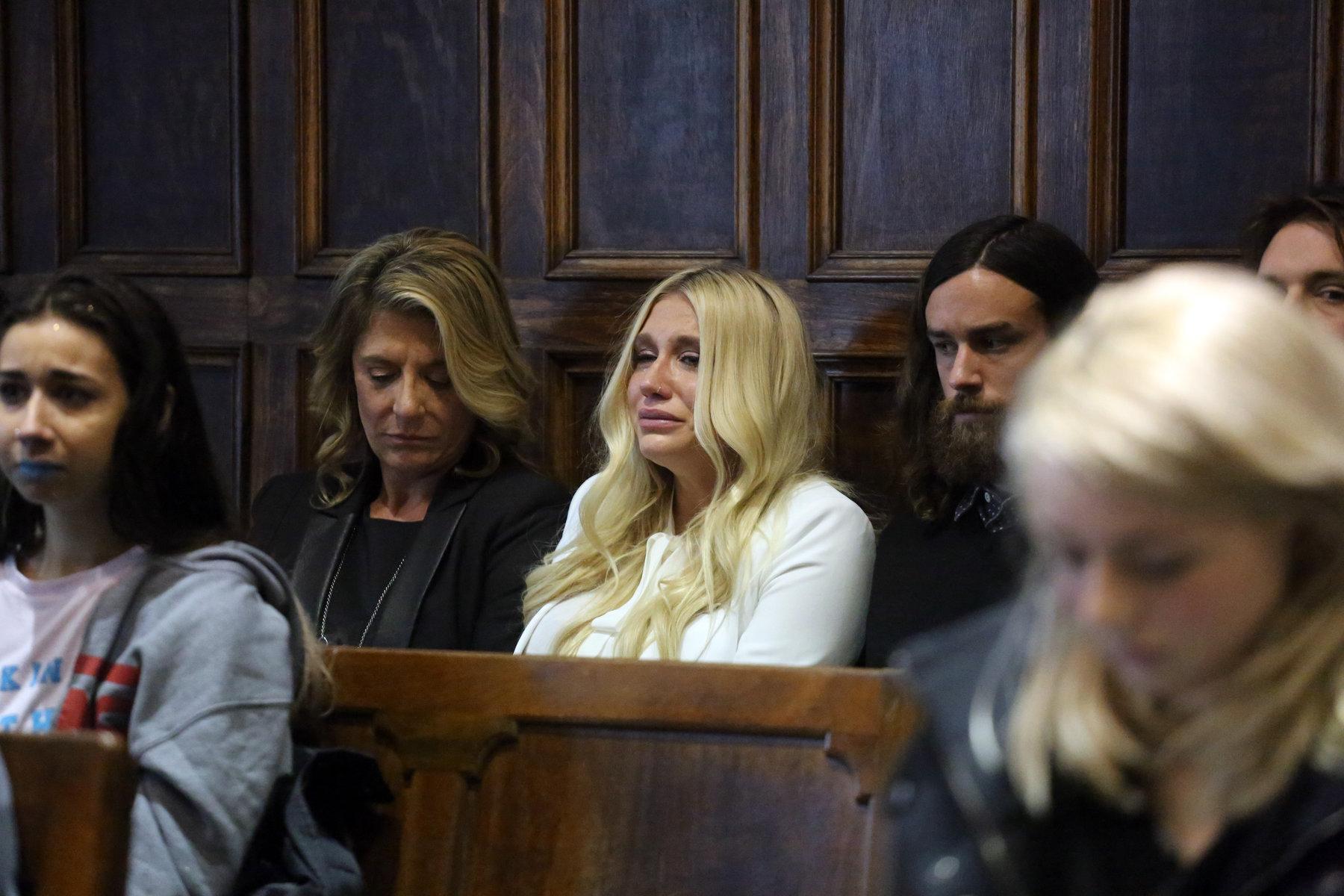 Kesha (center) crying at the ruling of her case against Dr. Luke