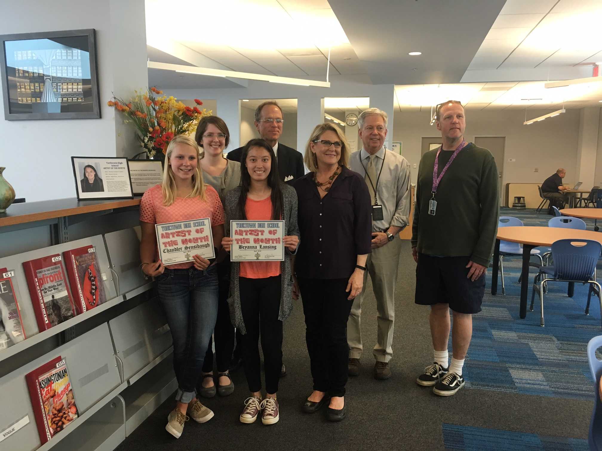 Juniors Chandler Sensibaugh (left) and Bryanna Lansing (front center left) accepting the award of Artist of the Month