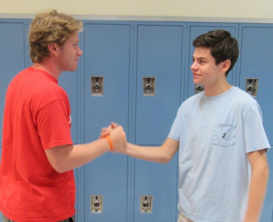 Jackson Cummings and Michael Lowen shake hands after finishing their interview
