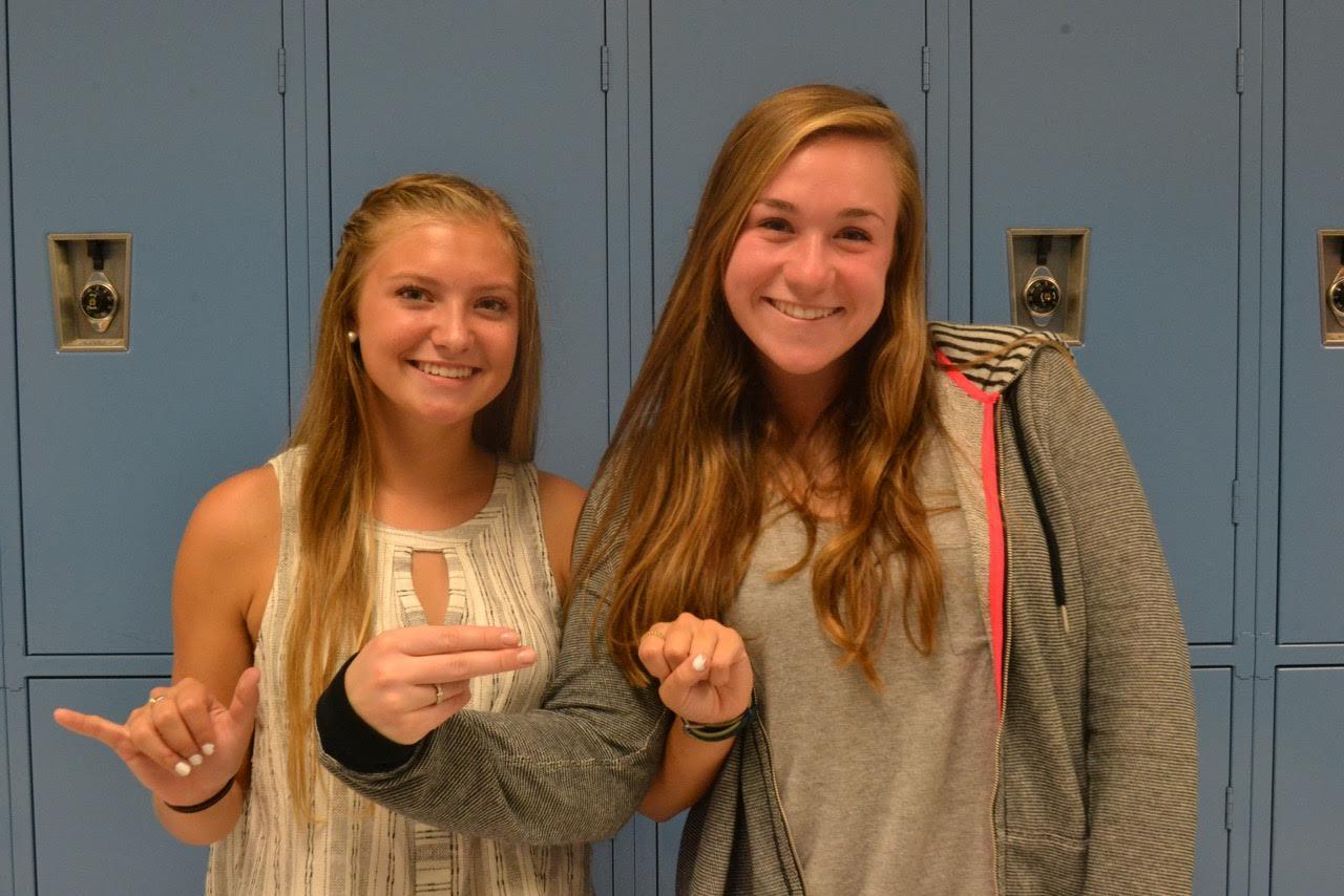 Sydney McMahon and Kate Cressey spell out YHS in Sign Language.