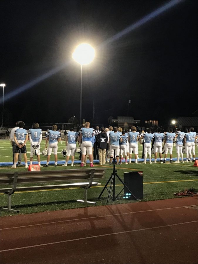 Yorktowns football team stands for the National Anthem