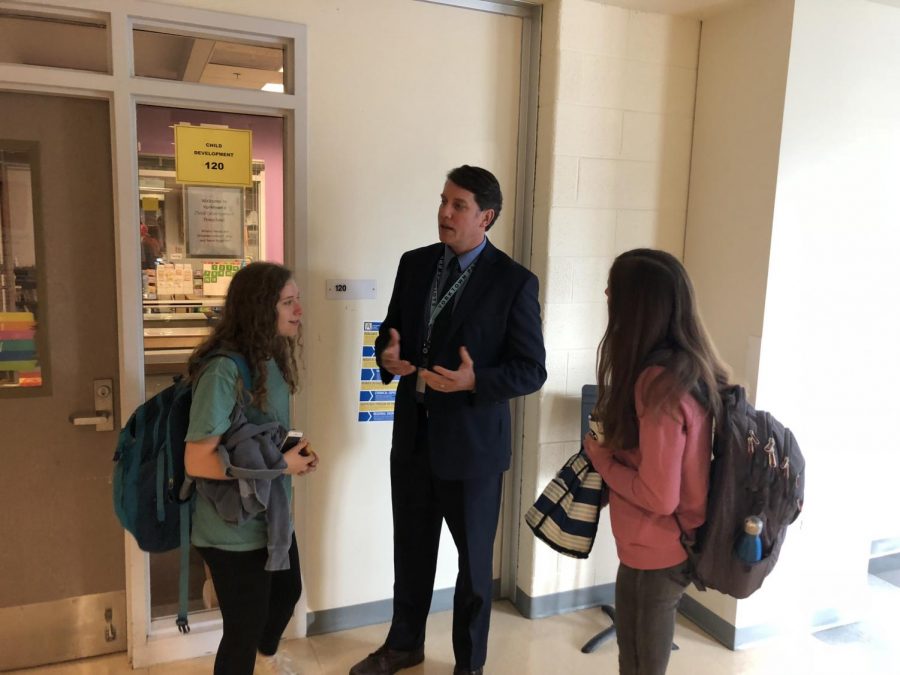 Mr. Conroy as he talks to students in the hallways.
