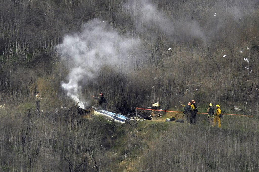 Firefighters at the scene of the helicopter crash.
