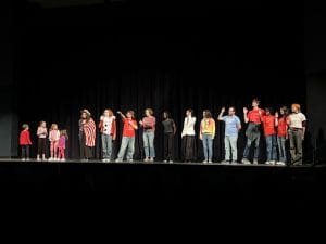 Variety show comes to a close, as all the participants reach the front of the stage.