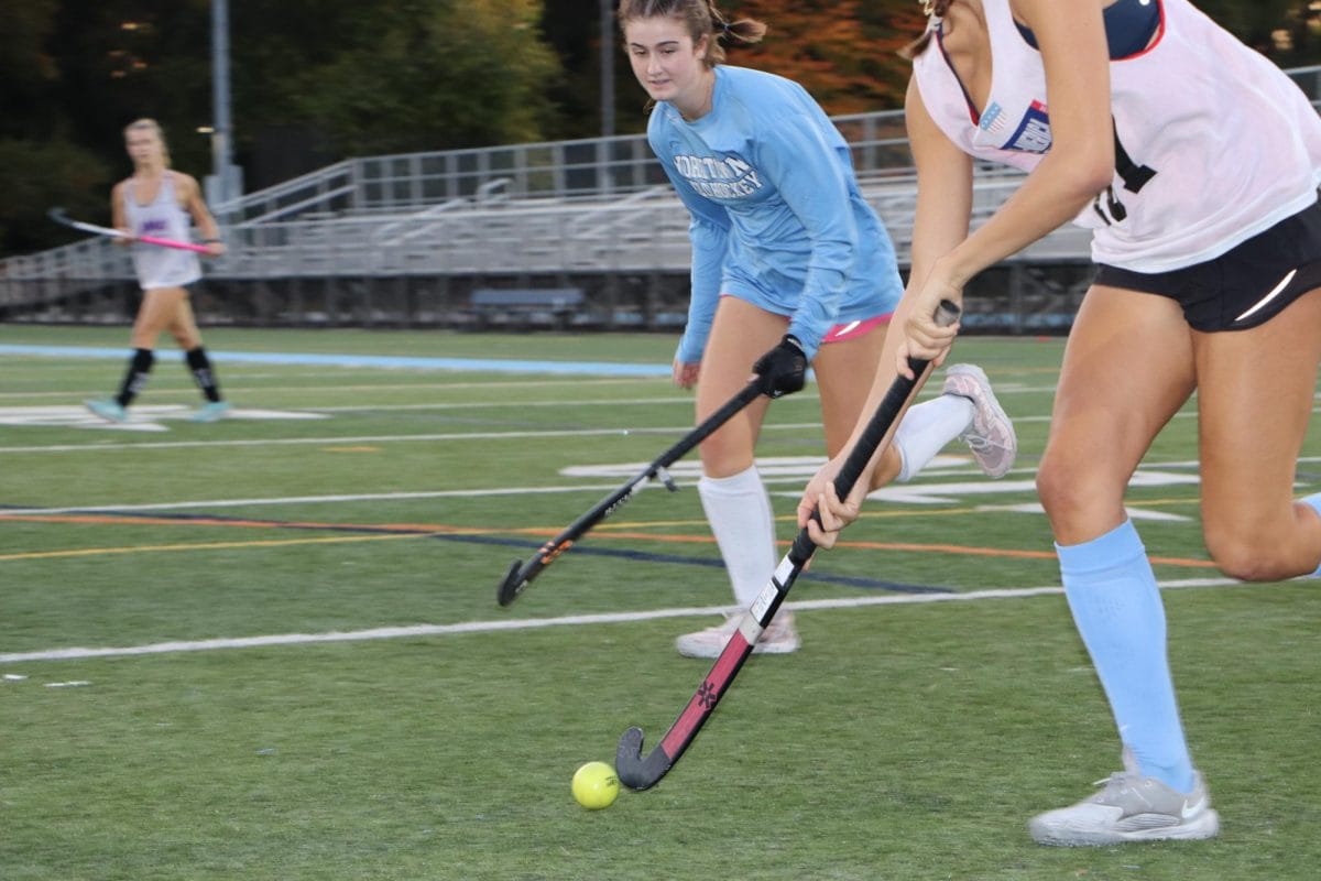 Junior Reagan Fruzzetti gets on defense at a varsity field hockey practice.