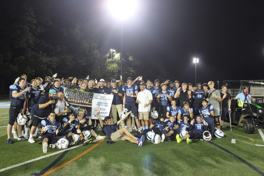 Our varsity football team poses with Coach Hansen to celebrate his 300th win.