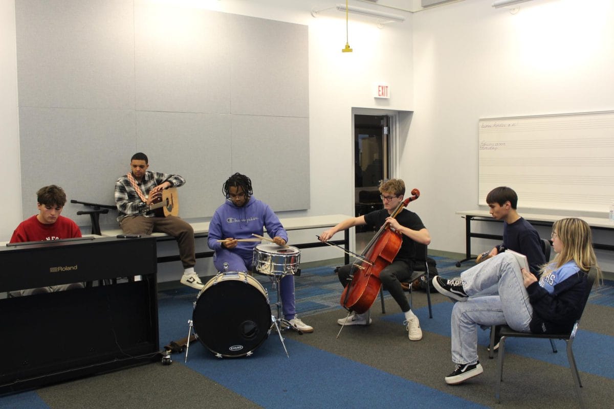 The Songwriting Club starting their meeting with a jam session.