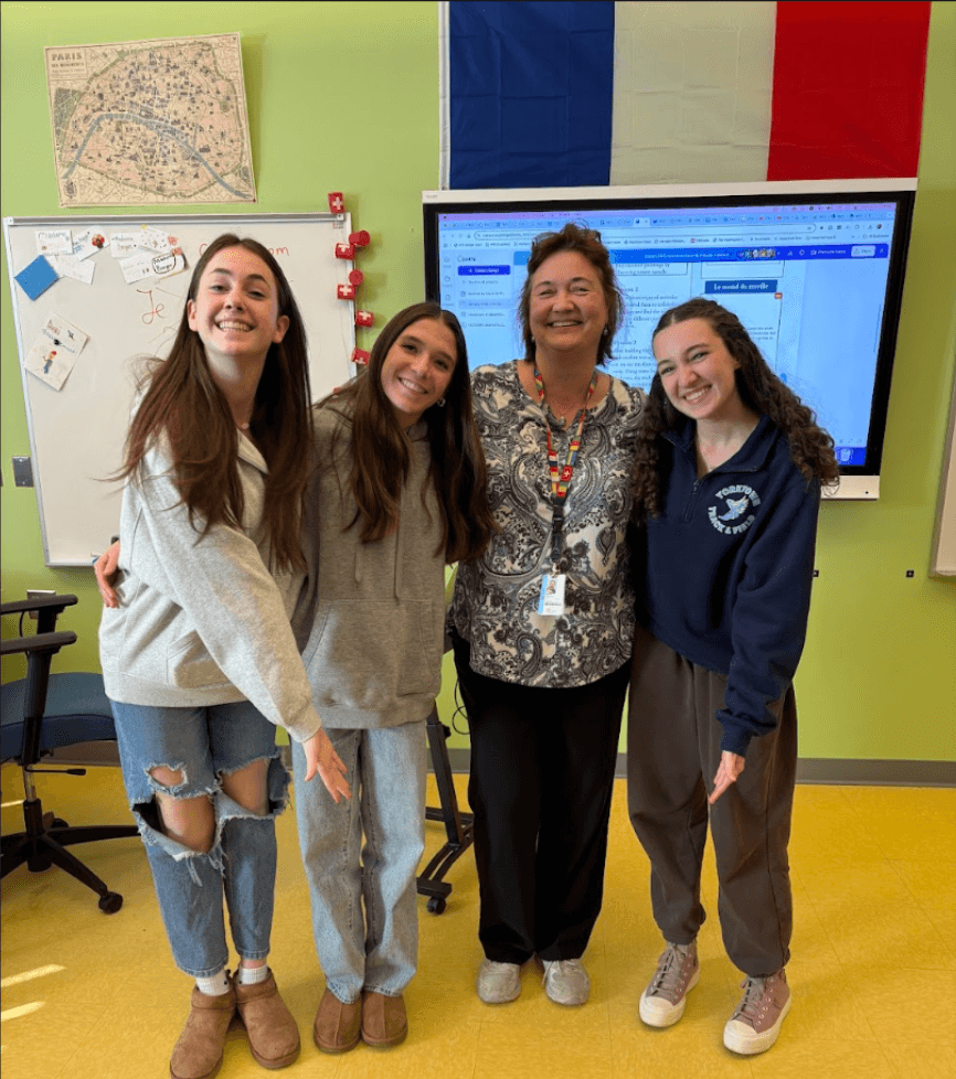 This is Madame Berger with 3 sophomores Sarah, Emily & Harper.