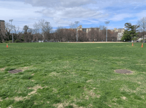 Kenmore middle schools soccer field has dirt patches covering the field.